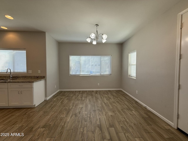 1720 W Pollack St, Phoenix, AZ 85041 - unfurnished dining area with dark wood-style floors, a chandelier, baseboards, a sink, and recessed lighting