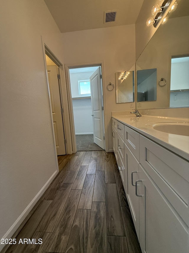1720 W Pollack St, Phoenix, AZ 85041 - bathroom featuring double vanity, wood finished floors, and baseboards