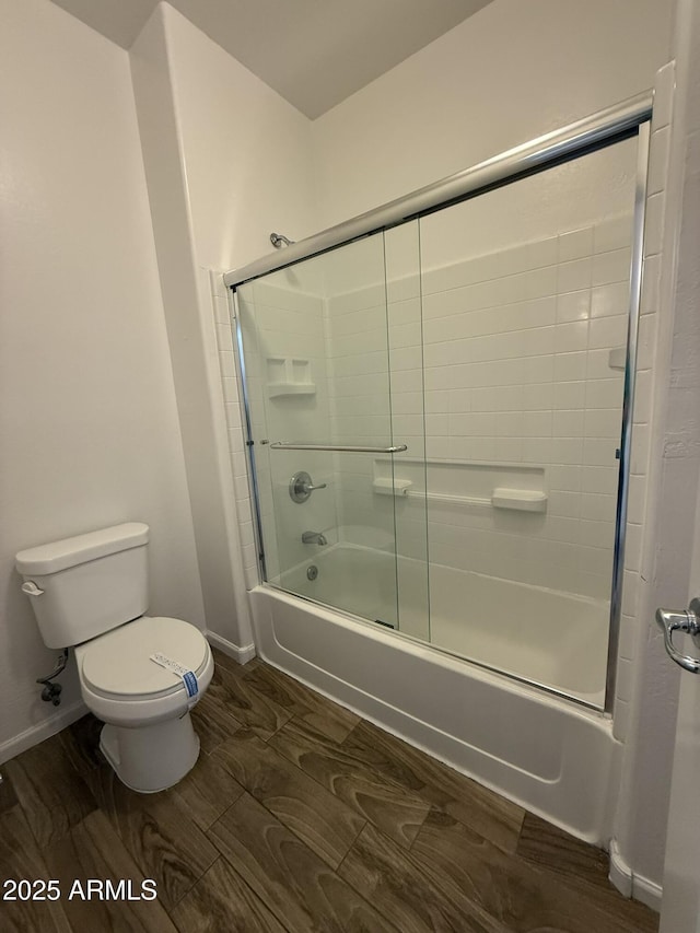 1720 W Pollack St, Phoenix, AZ 85041 - bathroom featuring toilet, enclosed tub / shower combo, baseboards, and wood finished floors