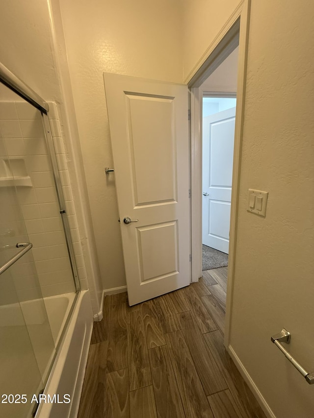 1720 W Pollack St, Phoenix, AZ 85041 - full bath featuring wood finished floors, baseboards, and shower / bath combination with glass door