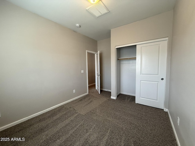 1720 W Pollack St, Phoenix, AZ 85041 - unfurnished bedroom featuring dark colored carpet, baseboards, and a closet