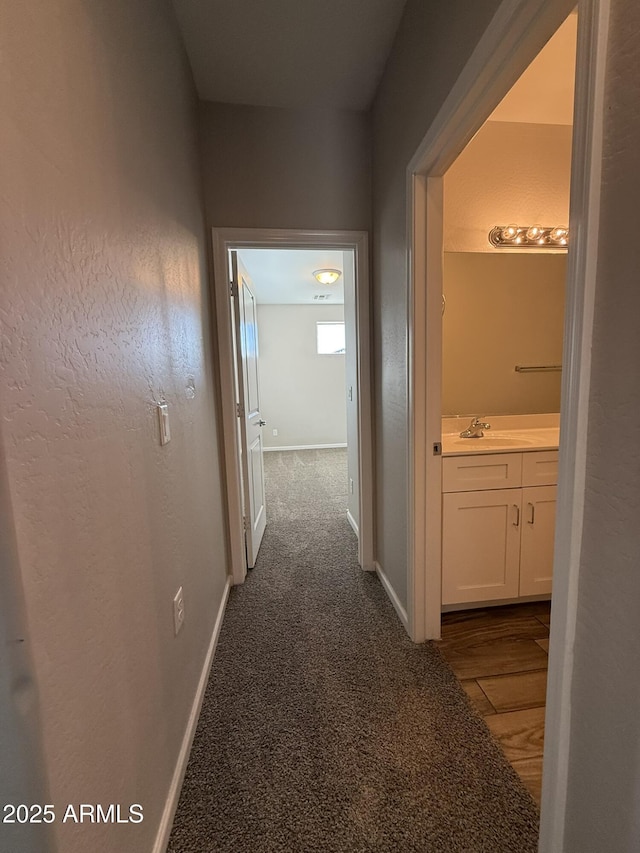 1720 W Pollack St, Phoenix, AZ 85041 - hall featuring baseboards, a sink, and dark wood-type flooring