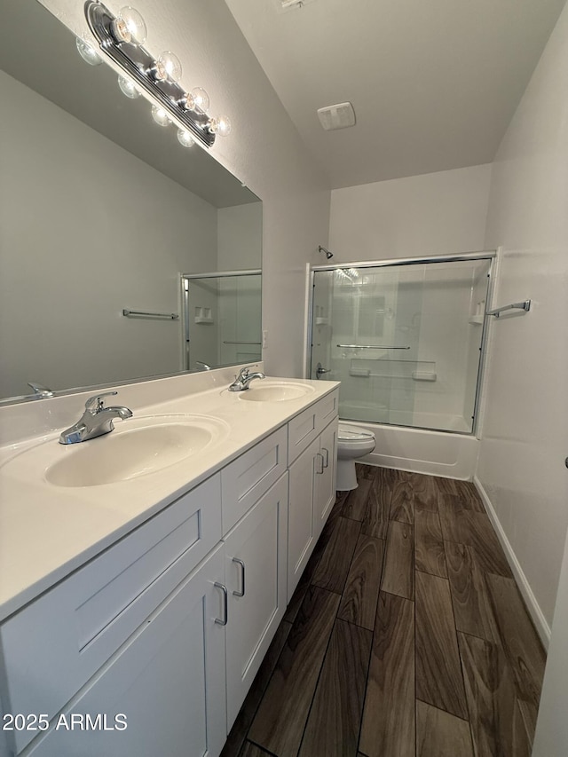 1720 W Pollack St, Phoenix, AZ 85041 - full bath with toilet, combined bath / shower with glass door, double vanity, and wood finished floors