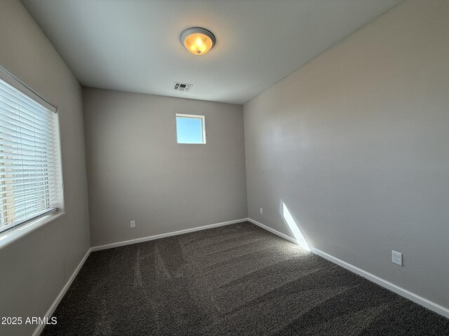 1720 W Pollack St, Phoenix, AZ 85041 - spare room featuring dark carpet and baseboards