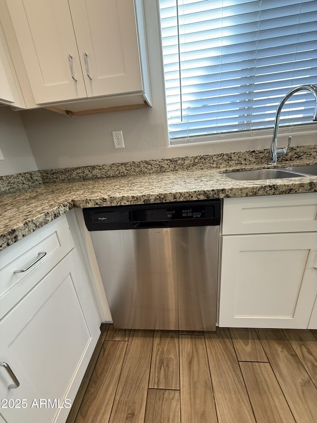 1720 W Pollack St, Phoenix, AZ 85041 - kitchen with dishwasher, a sink, white cabinets, wood finished floors, and light stone counters