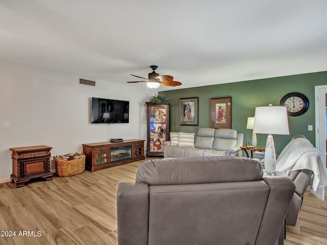 living room with ceiling fan and light hardwood / wood-style flooring