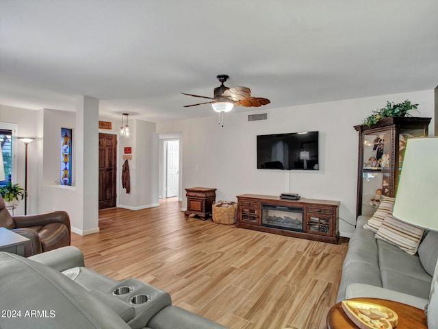 living room featuring ceiling fan and light hardwood / wood-style flooring