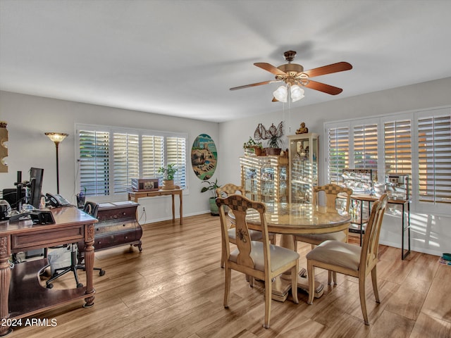 dining room featuring ceiling fan, light hardwood / wood-style floors, and a healthy amount of sunlight