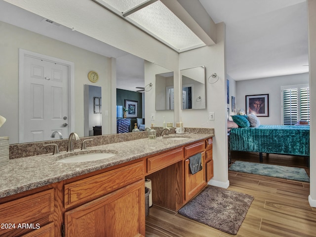 bathroom featuring hardwood / wood-style flooring and vanity