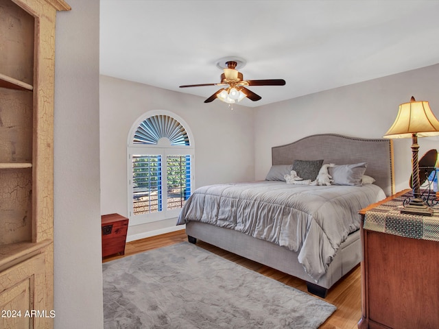 bedroom with ceiling fan and hardwood / wood-style floors