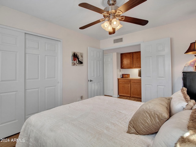 bedroom featuring a closet, hardwood / wood-style floors, and ceiling fan