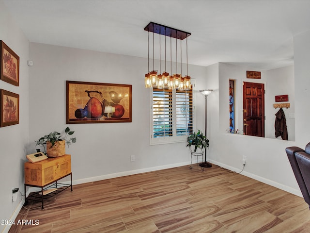 dining room featuring an inviting chandelier and light hardwood / wood-style flooring