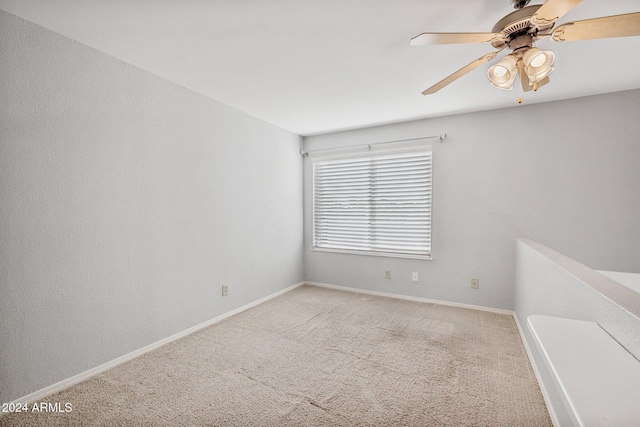 unfurnished room with ceiling fan and light colored carpet