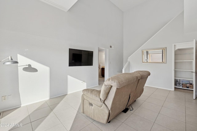 living room featuring light tile patterned floors and high vaulted ceiling