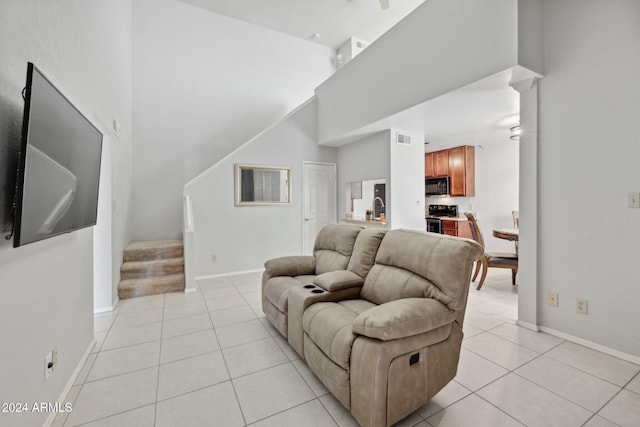 living room featuring light tile patterned floors and a high ceiling