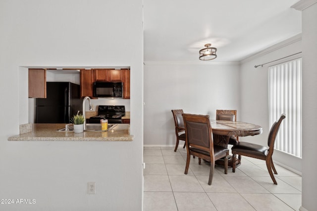 dining room featuring light tile patterned floors, ornamental molding, and sink