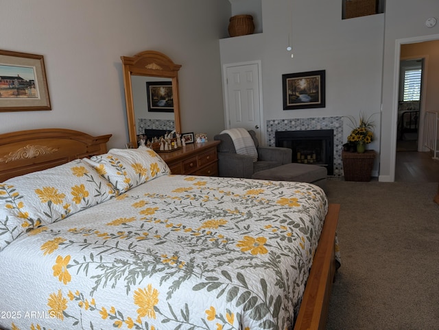 carpeted bedroom with a tiled fireplace