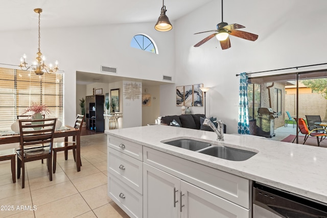 kitchen with visible vents, dishwasher, hanging light fixtures, light tile patterned flooring, and a sink