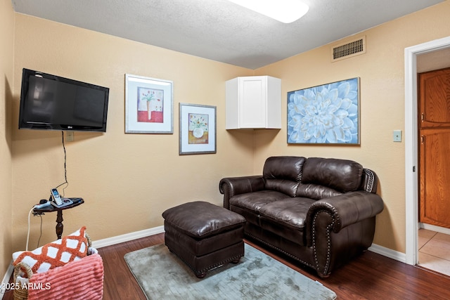 living room with visible vents, baseboards, and dark wood-type flooring