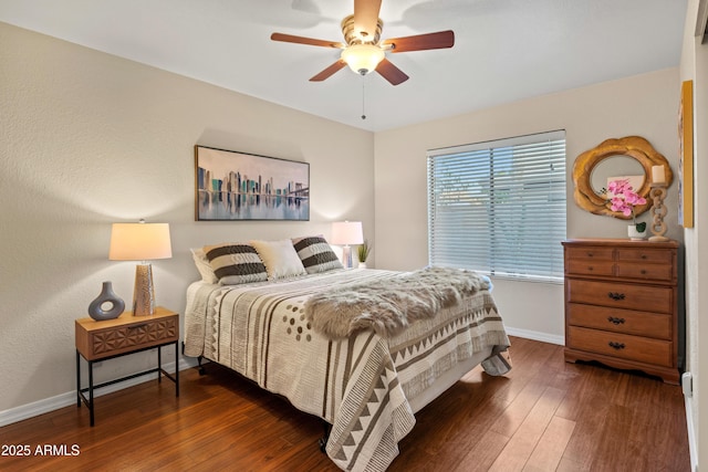 bedroom featuring ceiling fan, baseboards, and hardwood / wood-style floors