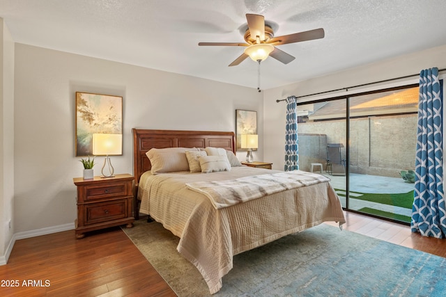 bedroom featuring access to exterior, baseboards, hardwood / wood-style flooring, a textured ceiling, and a ceiling fan