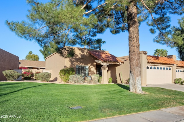 mediterranean / spanish home with stucco siding, a front lawn, concrete driveway, an attached garage, and a tiled roof