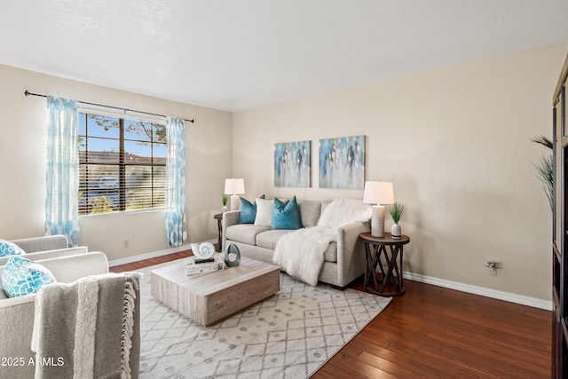 living area with baseboards and wood finished floors