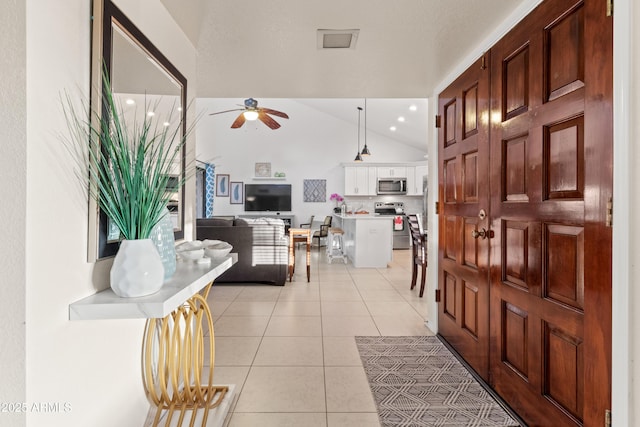 foyer with light tile patterned flooring, recessed lighting, ceiling fan, and vaulted ceiling