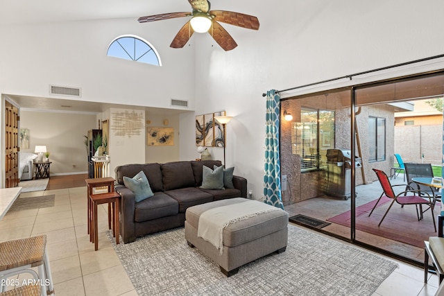 living area with light tile patterned floors, visible vents, and a healthy amount of sunlight