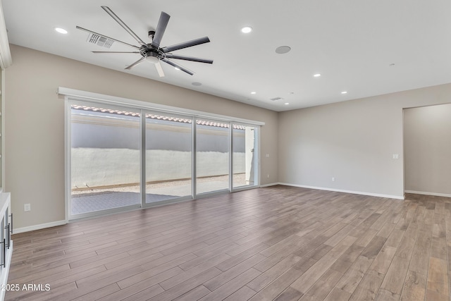 unfurnished living room with recessed lighting, ceiling fan, baseboards, and wood finished floors