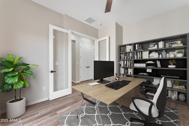 office featuring baseboards, visible vents, ceiling fan, wood finished floors, and french doors