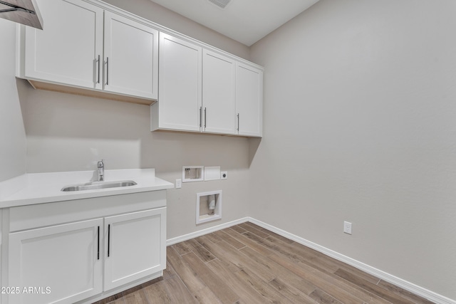 clothes washing area featuring cabinet space, baseboards, hookup for an electric dryer, washer hookup, and a sink