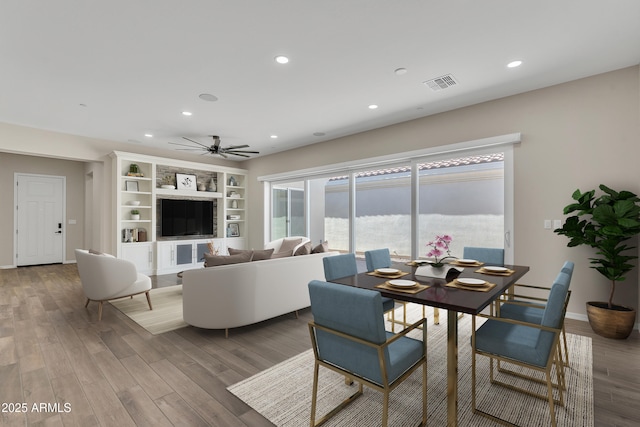 living area with ceiling fan, visible vents, wood finished floors, and recessed lighting