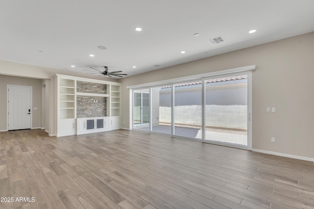 unfurnished living room with light wood finished floors, visible vents, and recessed lighting