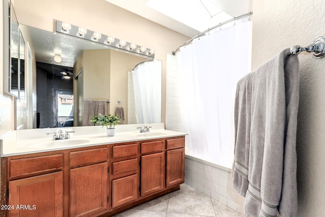 bathroom with tile patterned flooring, shower / tub combo, vanity, and ceiling fan