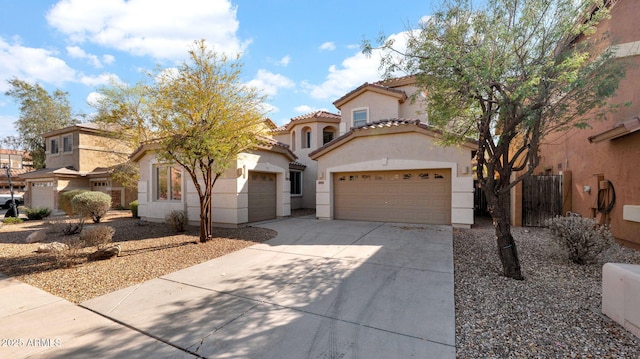 mediterranean / spanish-style home featuring stucco siding, fence, a garage, driveway, and a tiled roof