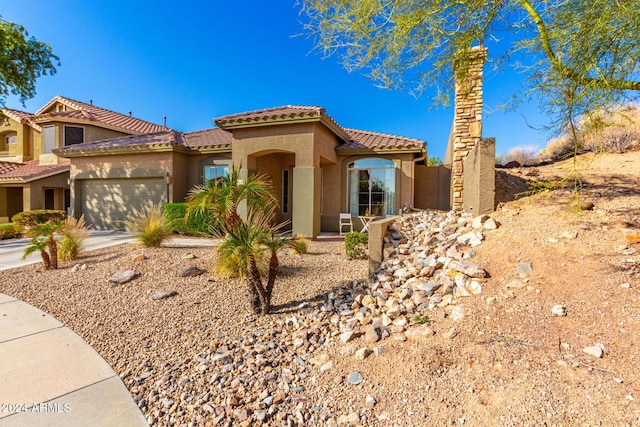 mediterranean / spanish-style home featuring a garage