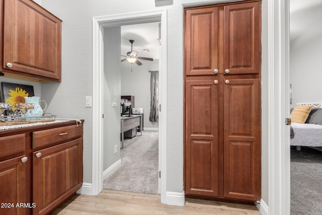 kitchen featuring light wood-type flooring and ceiling fan