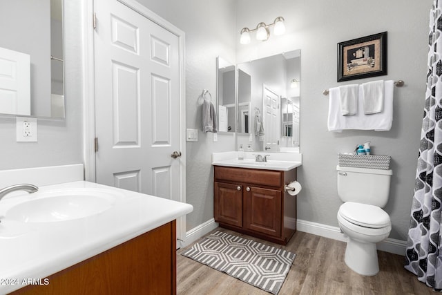 bathroom featuring hardwood / wood-style flooring, vanity, and toilet