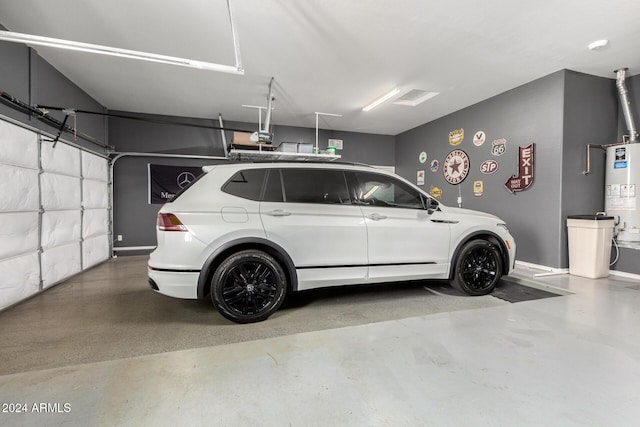 garage with a garage door opener and gas water heater