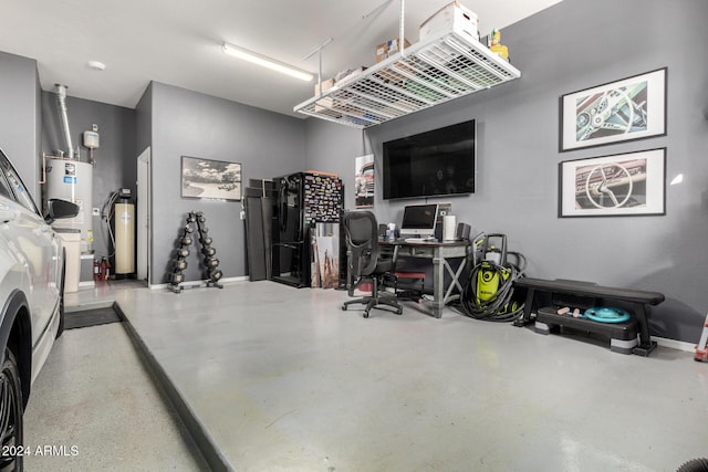 garage with water heater and washer and clothes dryer