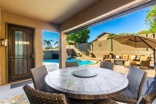 view of patio with outdoor lounge area and a fenced in pool