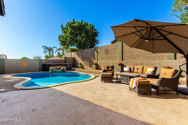 view of pool with an outdoor living space and a patio area