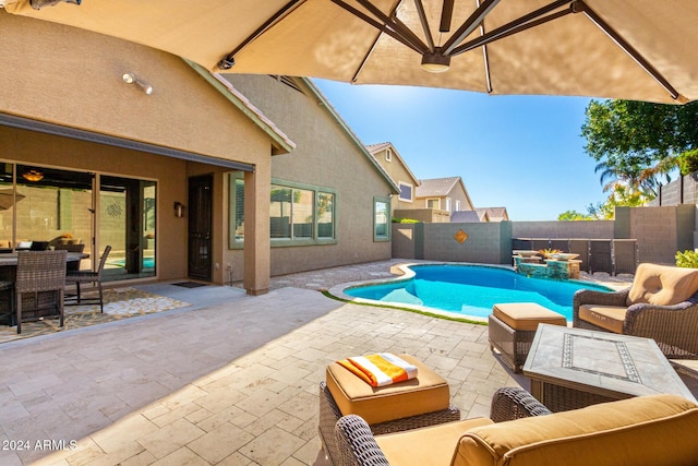 view of pool featuring an outdoor living space and a patio area