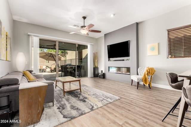 living room with ceiling fan and light hardwood / wood-style floors