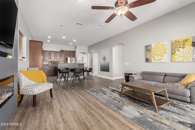 living room with ceiling fan and wood-type flooring