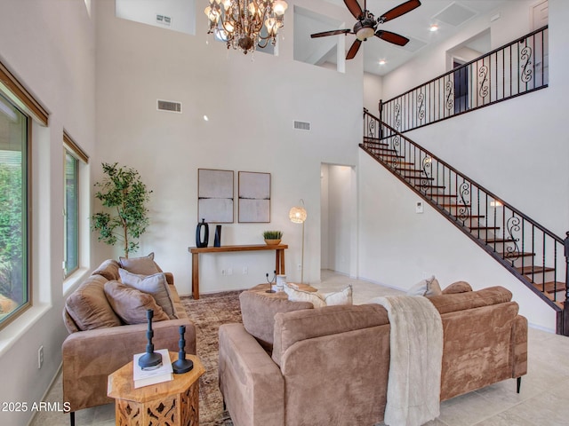 living room featuring ceiling fan with notable chandelier