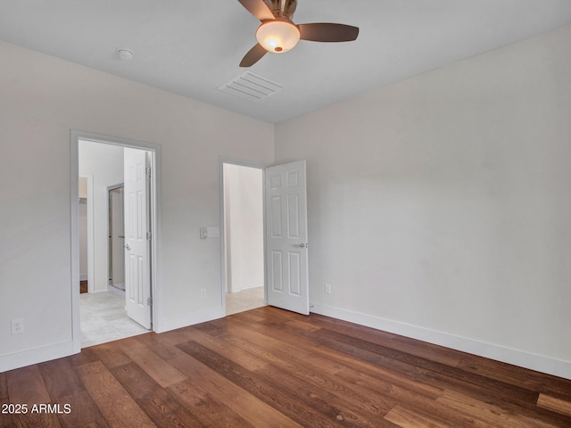 unfurnished bedroom featuring ceiling fan, ensuite bathroom, and light hardwood / wood-style flooring