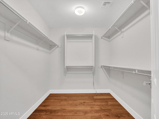 spacious closet featuring hardwood / wood-style floors