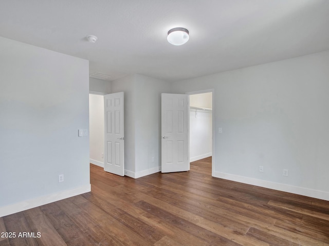 spare room with dark wood-type flooring